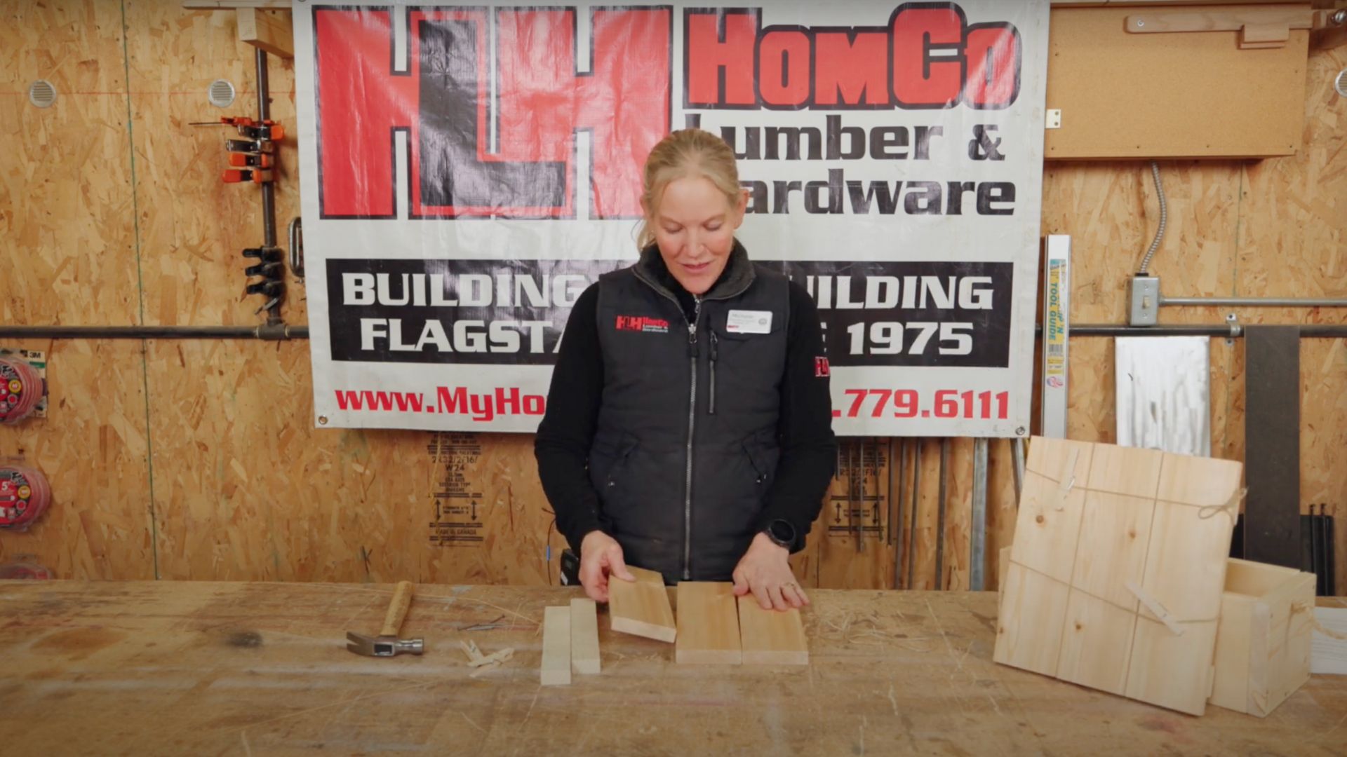 woman lining up wooden planks 